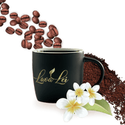 Coffee cup featuring the Lava Lei logo, with a background of coffee beans and coffee powder. Plumeria flowers as decoration
